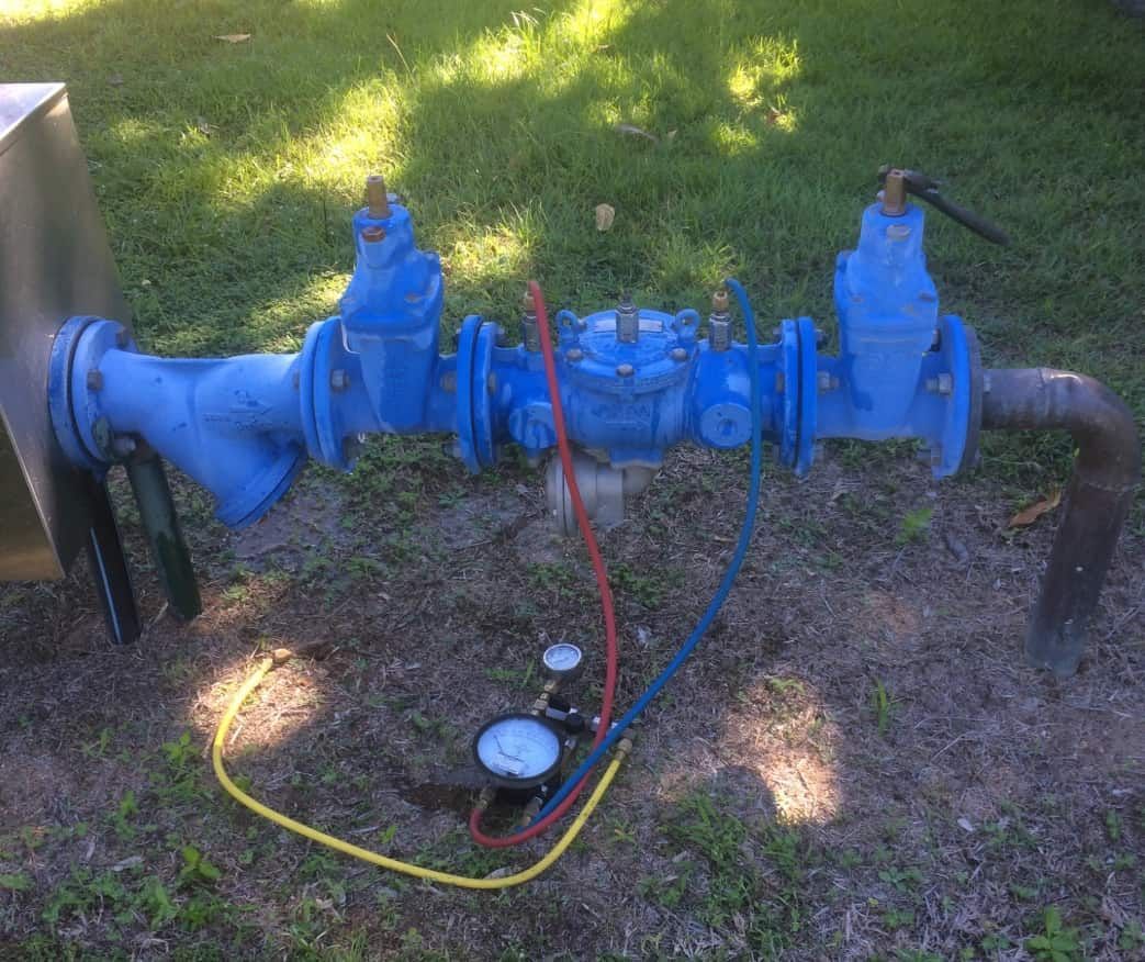 A Blue Pipe With Two Gauges Attached to It is Sitting on the Ground — Northern Plumbing In Mount Louisa, QLD