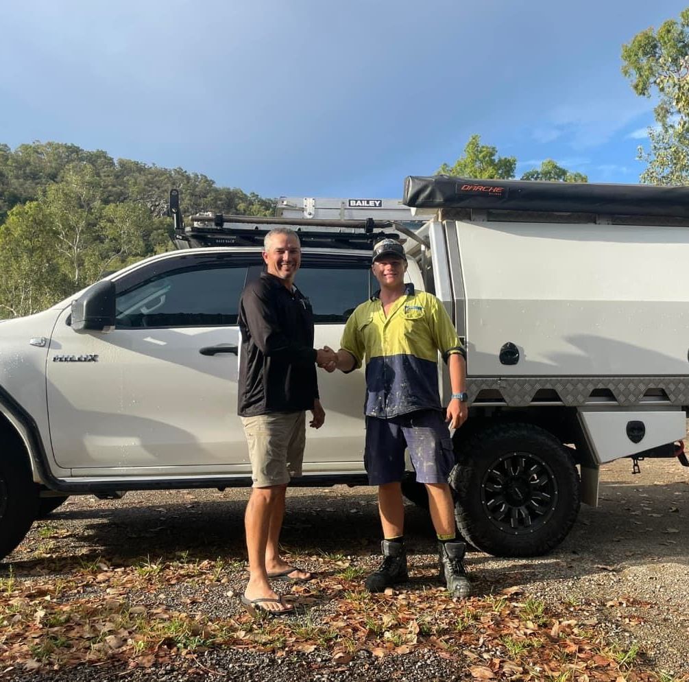 Two Men Shaking Hands in Front of a White Truck — Northern Plumbing In Mount Louisa, QLD