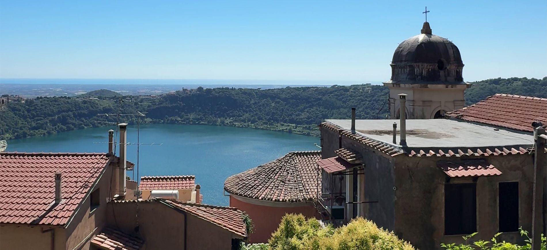 Lago di Nemi visto dall'alto con il borgo arroccato tra i boschi dei Castelli Romani nel Lazio