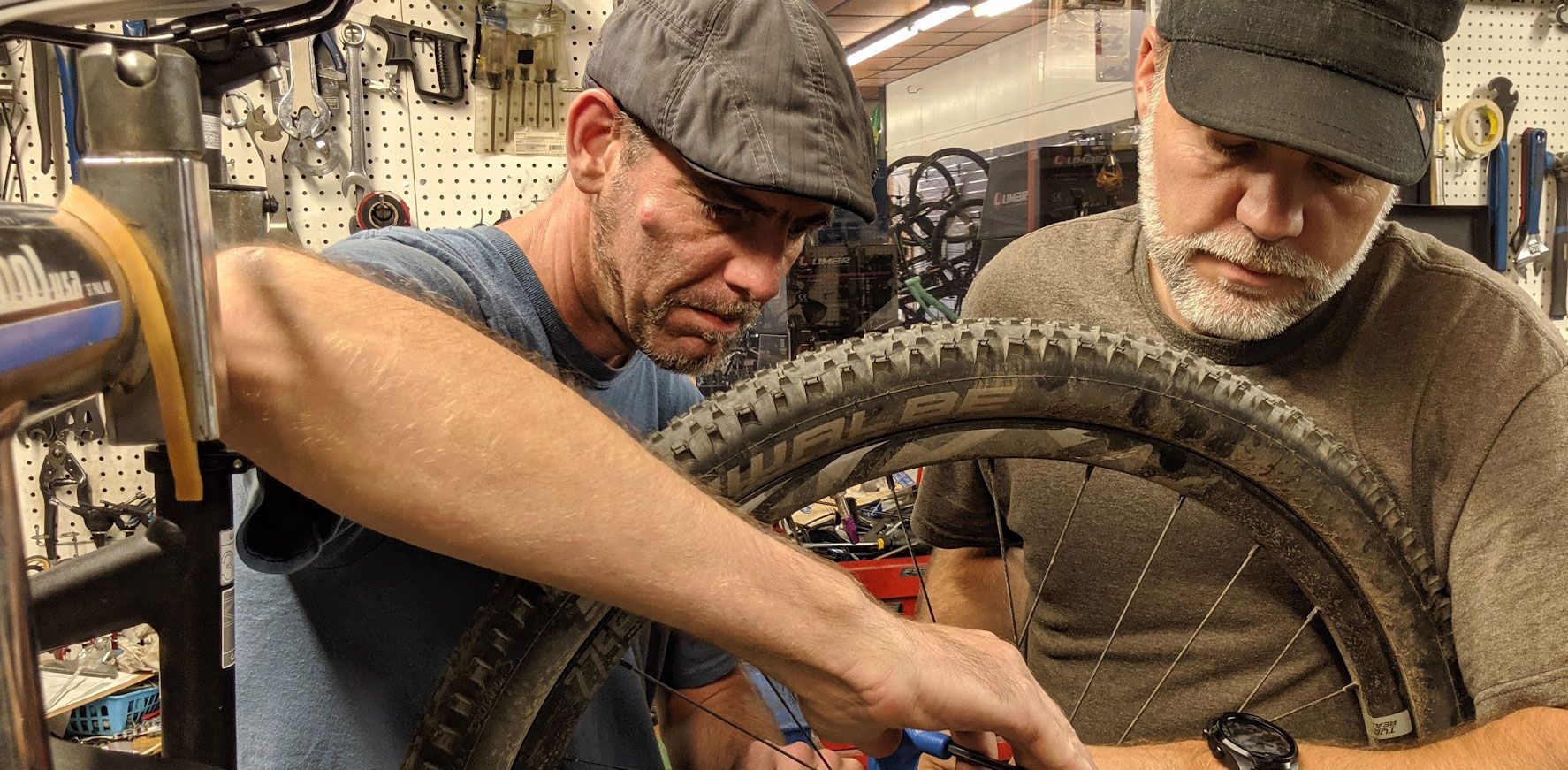 Eric Phillips and his brother working on a bike at Skinny Wheels Bike Shop in Salisbury NC