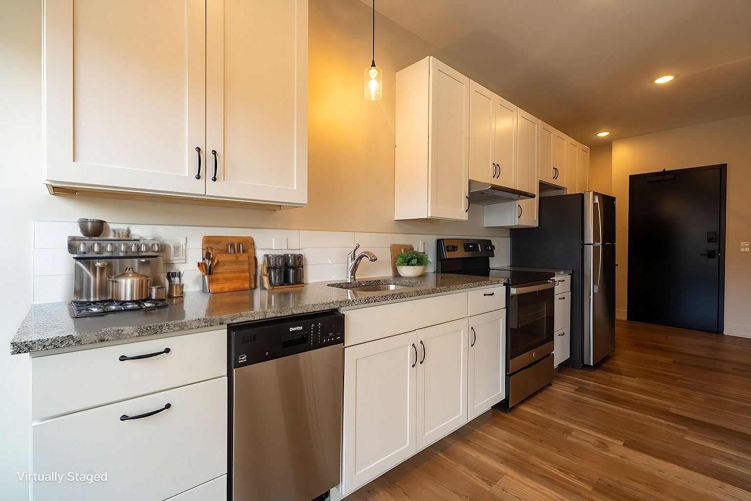 Photo of a kitchen, showing the entrance in the background