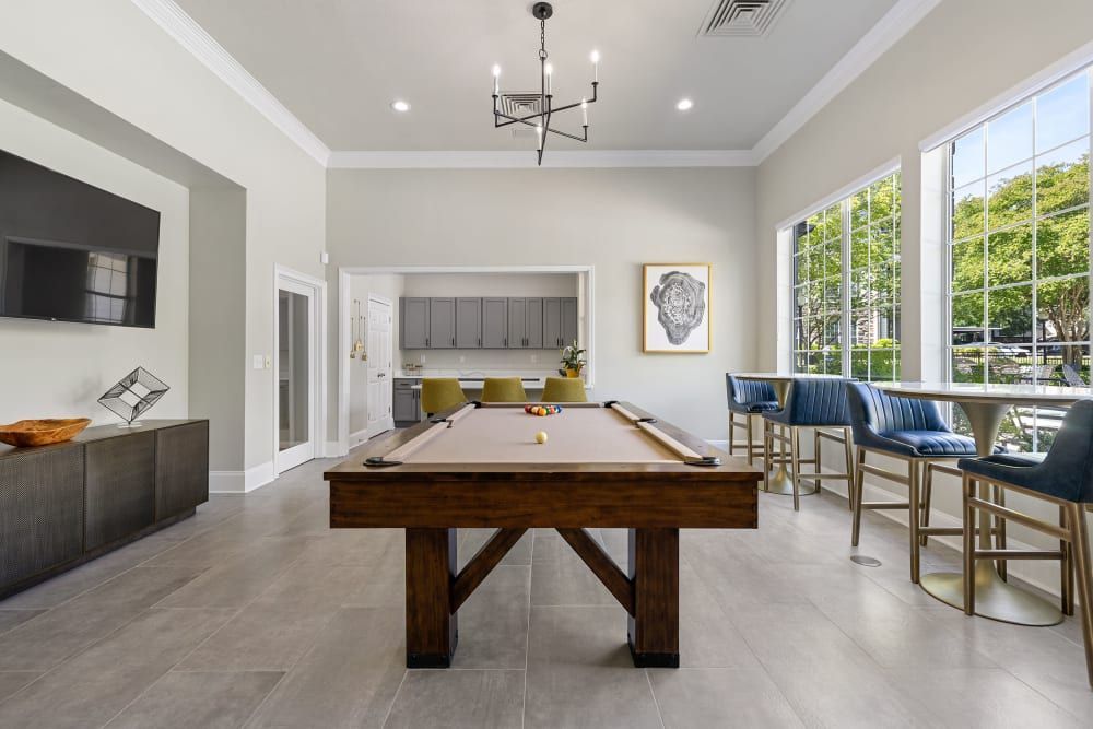 a pool table in the middle of the room at Marquis Carmel Commons in Charlotte, NC.