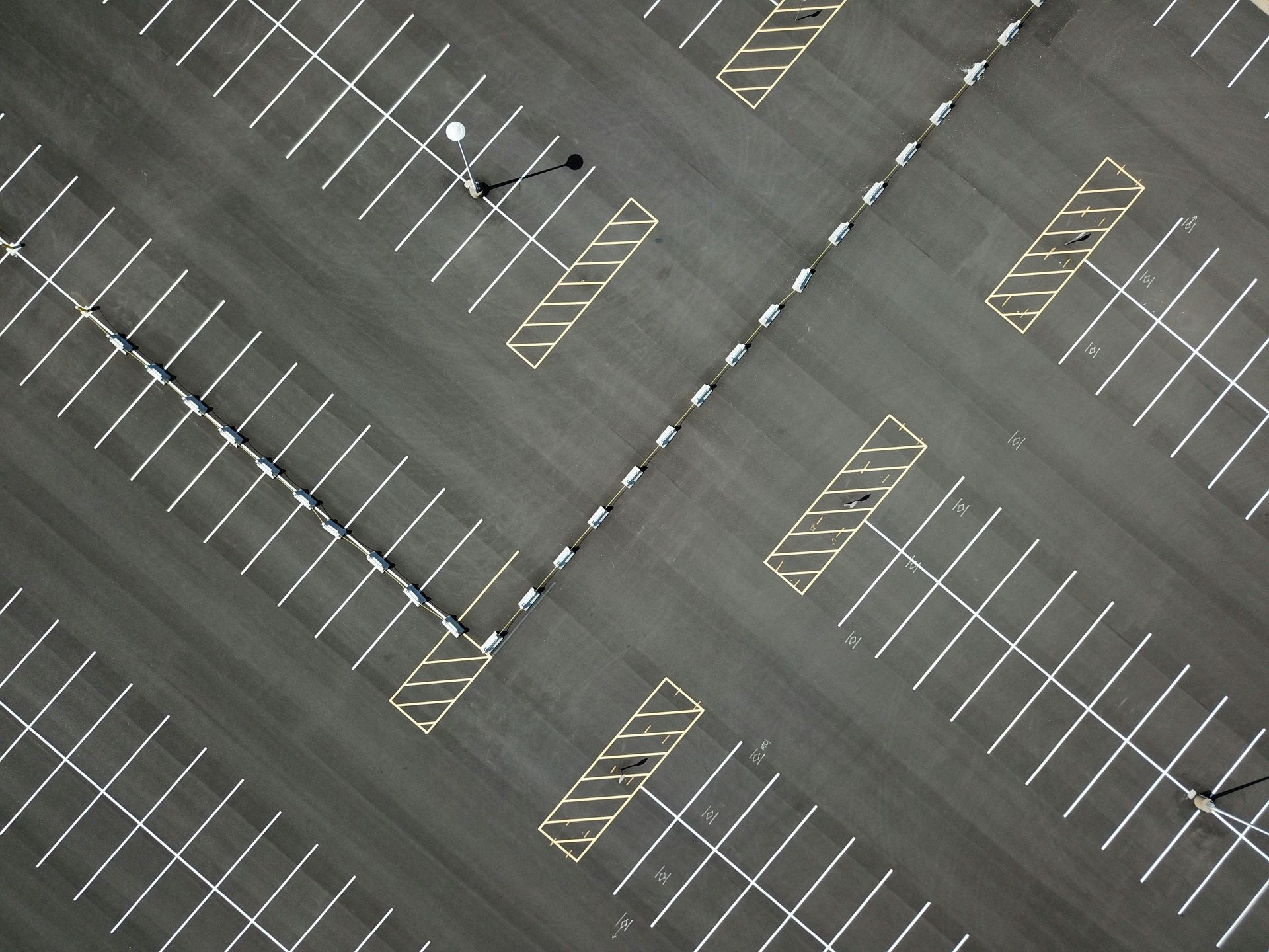 Empty parking lot with diagonal white and yellow parking lines