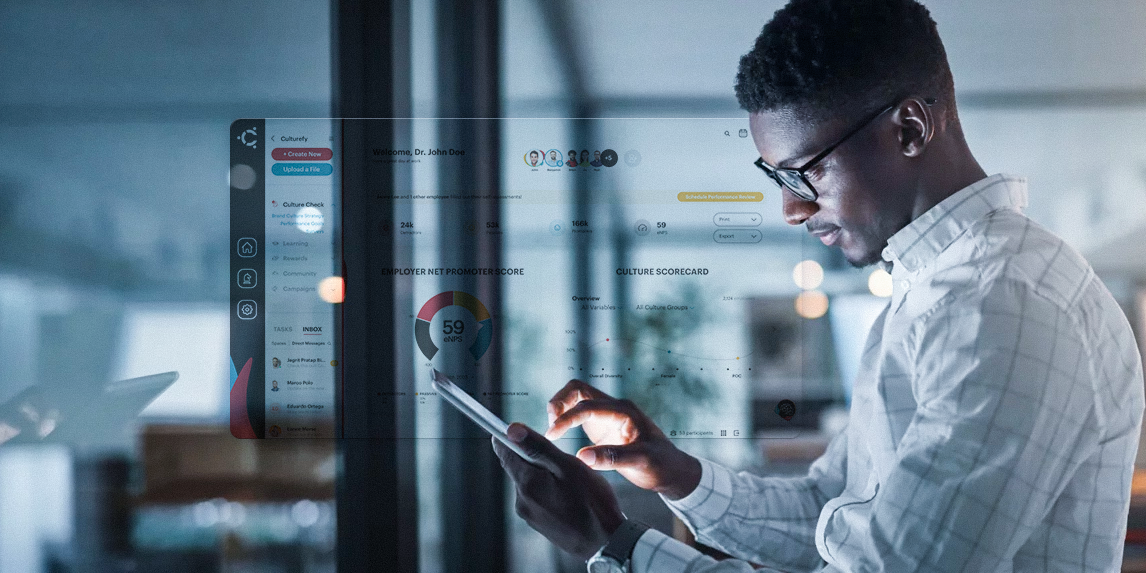 A man is using a tablet computer in an office.