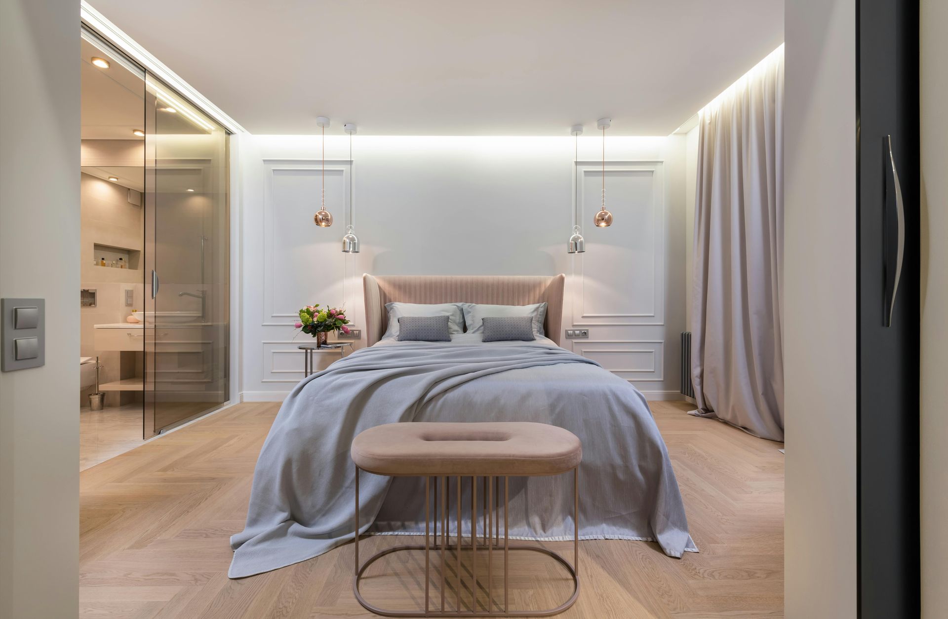 A bedroom with a king size bed and a bench.