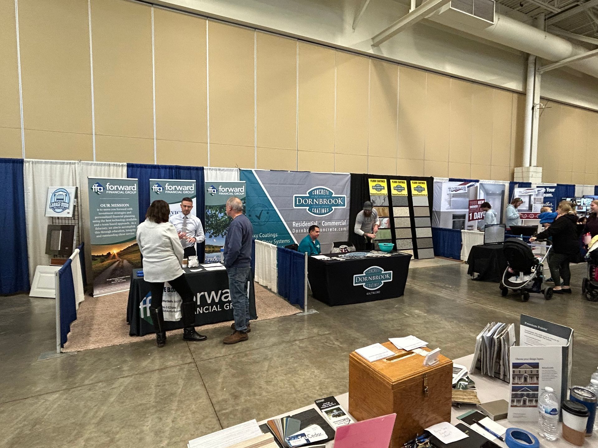 A group of people are standing around a table at a trade show.