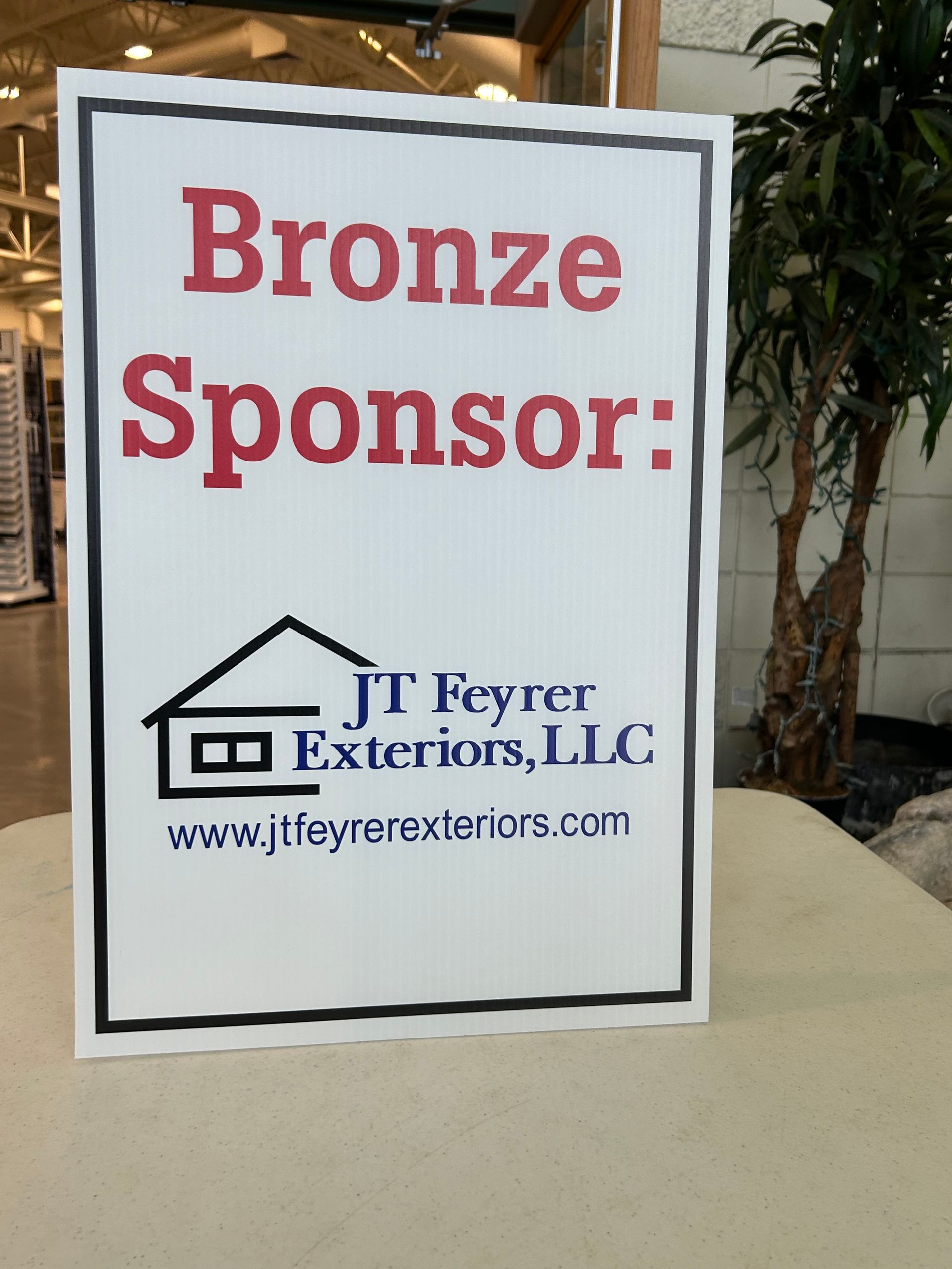 A sign that says bronze sponsor on it