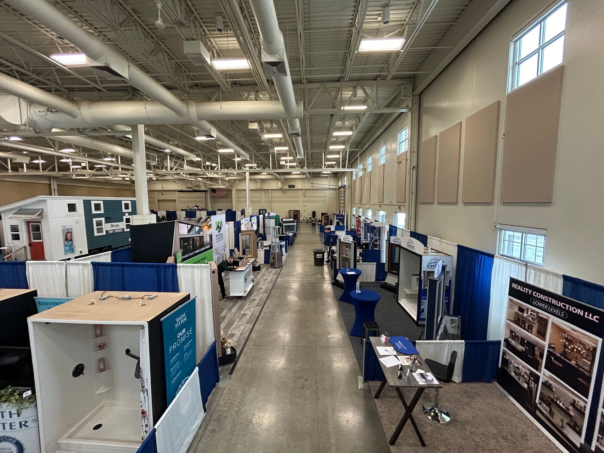 A large room filled with lots of booths and tables.