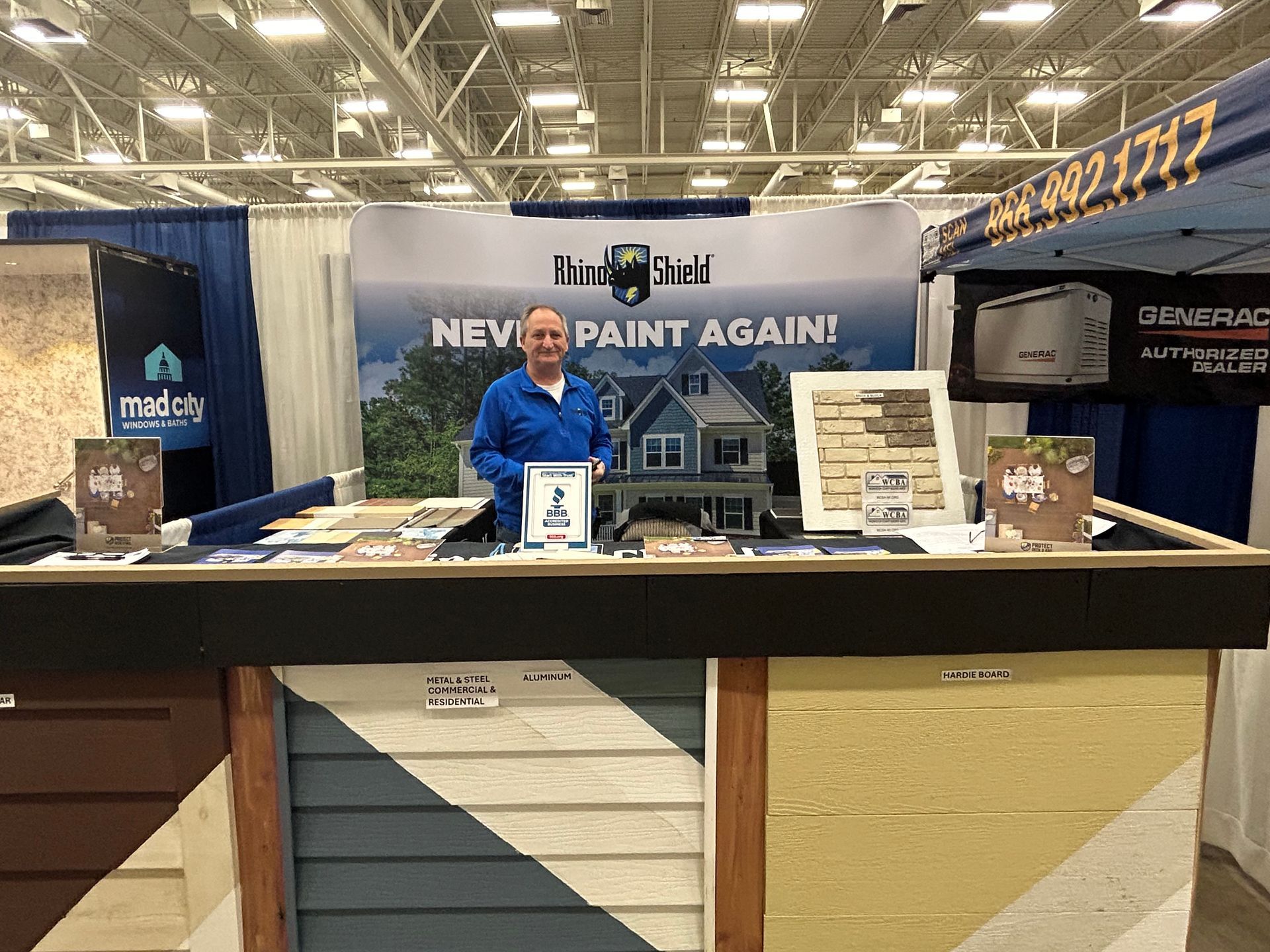 A man is standing in front of a sign that says `` never paint again ''.
