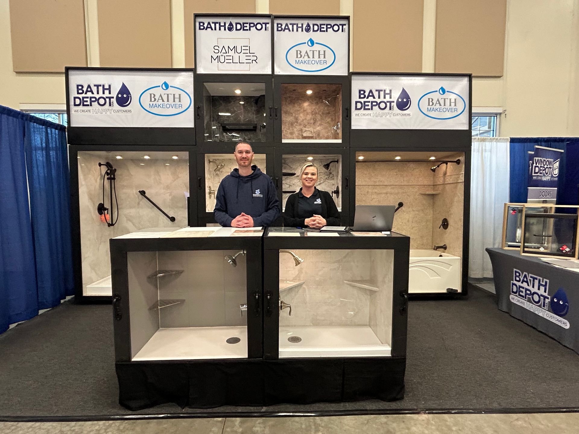 Two men are standing in front of a bathroom depot booth.