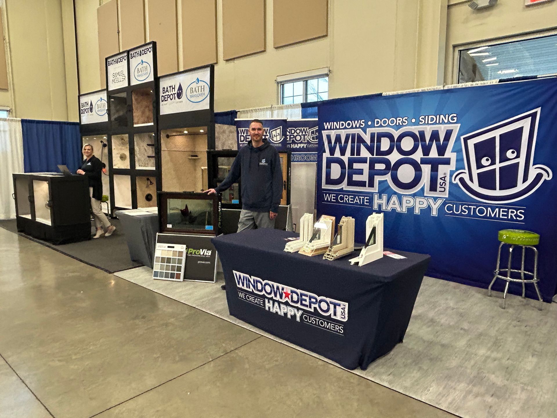 A man is standing in front of a window depot booth.