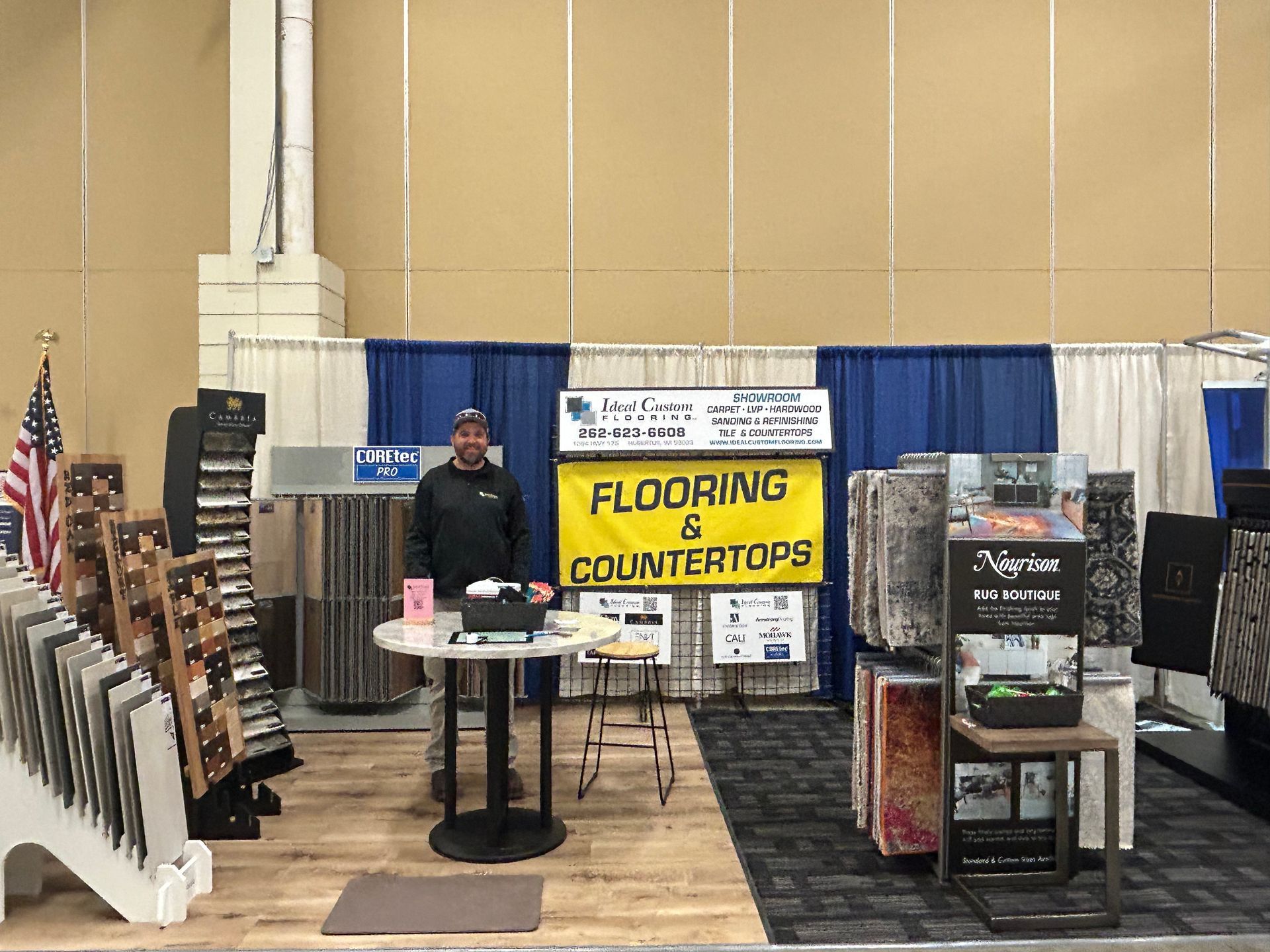 A man is standing in front of a sign that says flooring and counter tops.