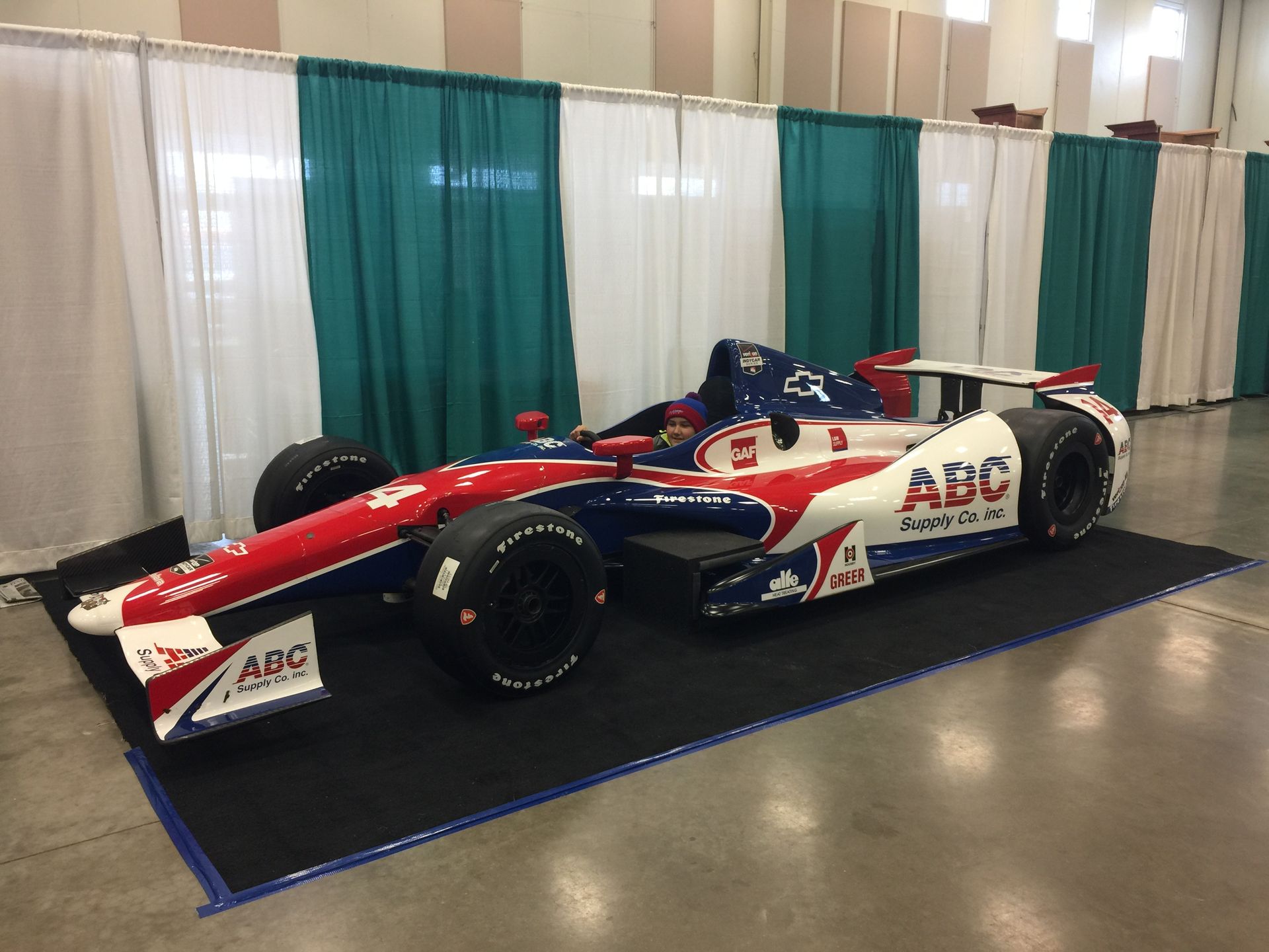 A red white and blue race car with the word abc on the side