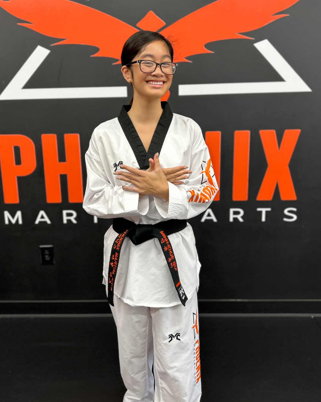 Minh-Khue today as a black belt and student leader at Phoenix Martial Arts