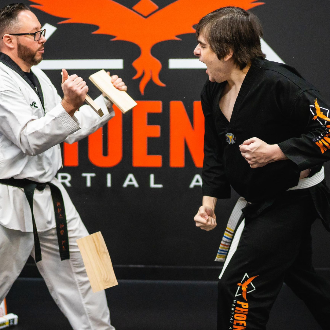 Adult martial arts student preparing for a board breaking demonstration at Phoenix Martial Arts in Murfreesboro, TN