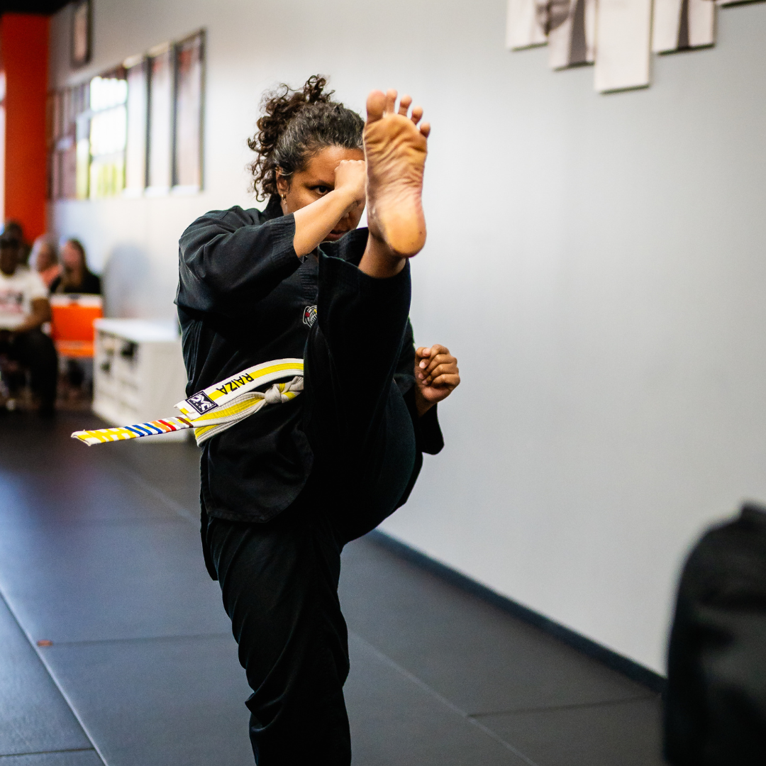 Adult martial arts student performing a front kick during Taekwondo class at Phoenix Martial Arts in Murfreesboro, TN