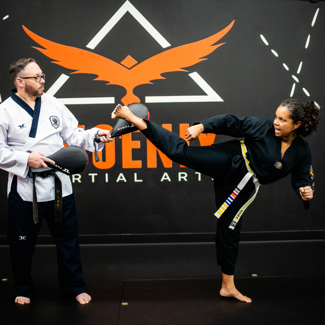 Adult martial arts student performing a hook kick during Taekwondo class at Phoenix Martial Arts in Murfreesboro, TN