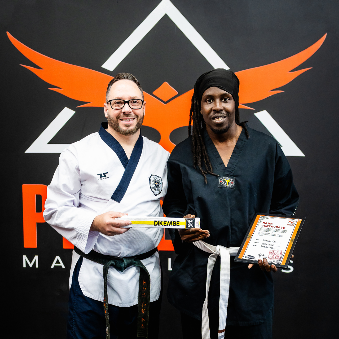 Adult martial arts student celebrating a belt promotion at Phoenix Martial Arts in Murfreesboro, TN