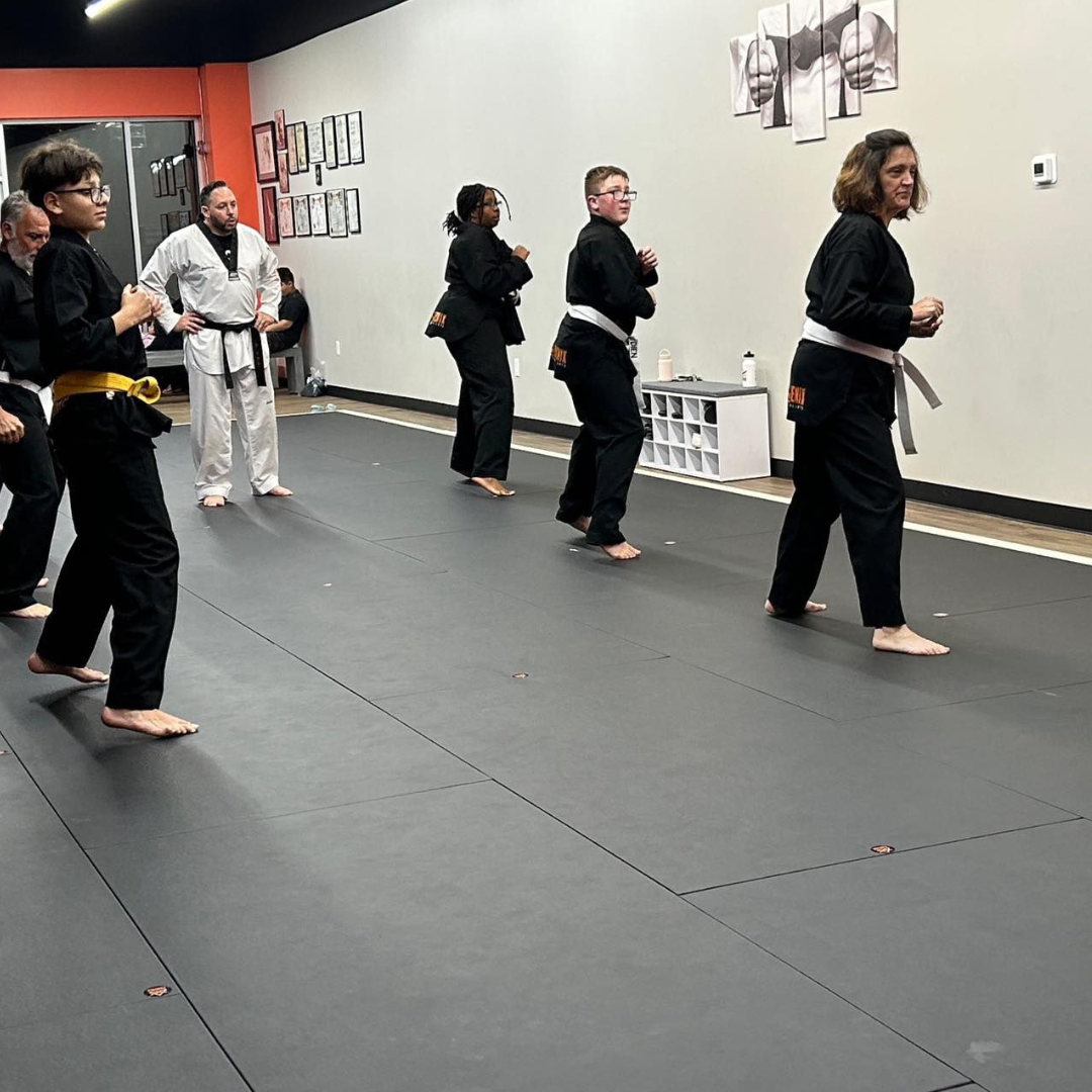 Adult martial arts students warming up before Taekwondo class at Phoenix Martial Arts in Murfreesboro, TN