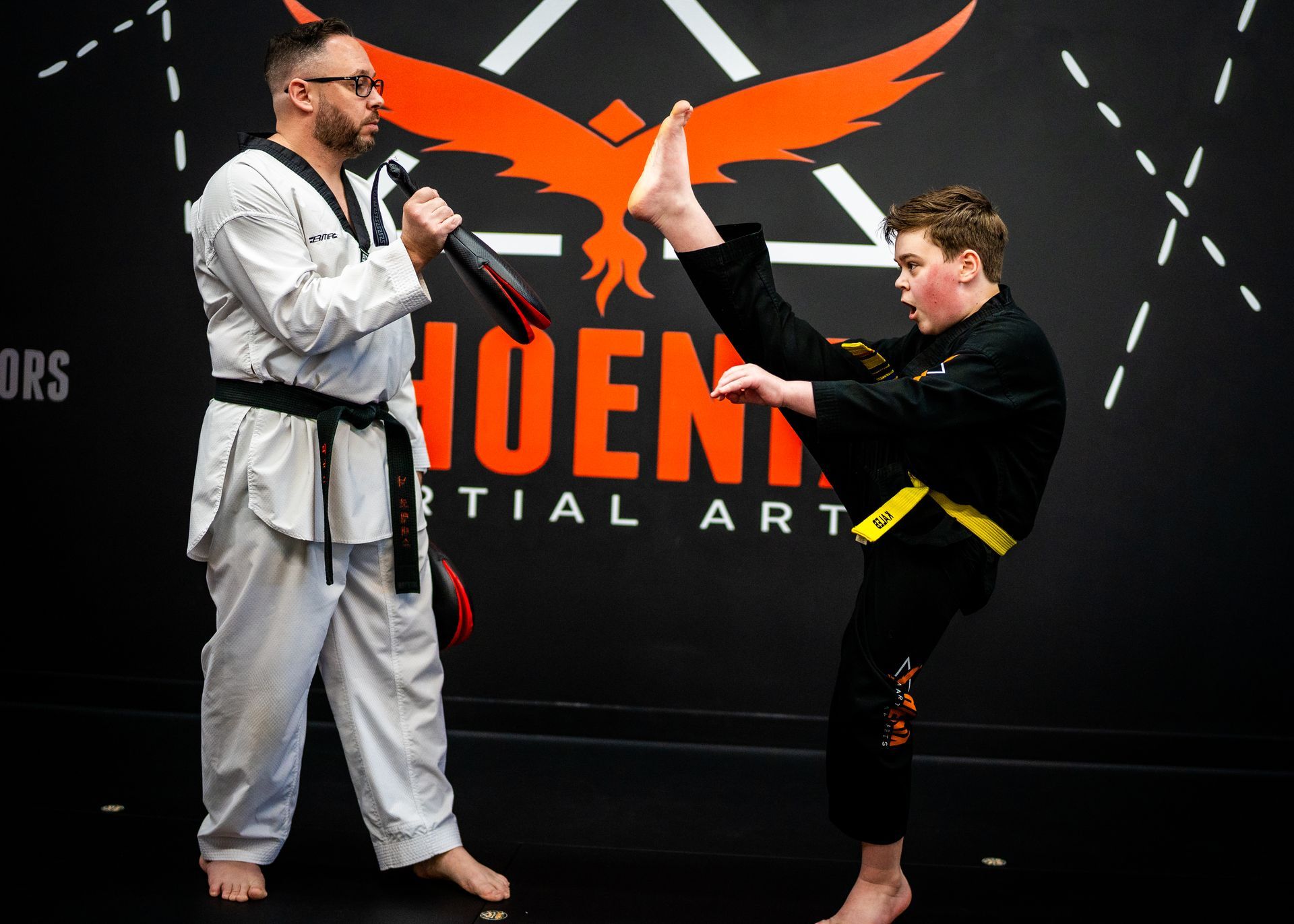 Young student practicing an axe kick during kids martial arts class at Phoenix Martial Arts in Murfreesboro, TN