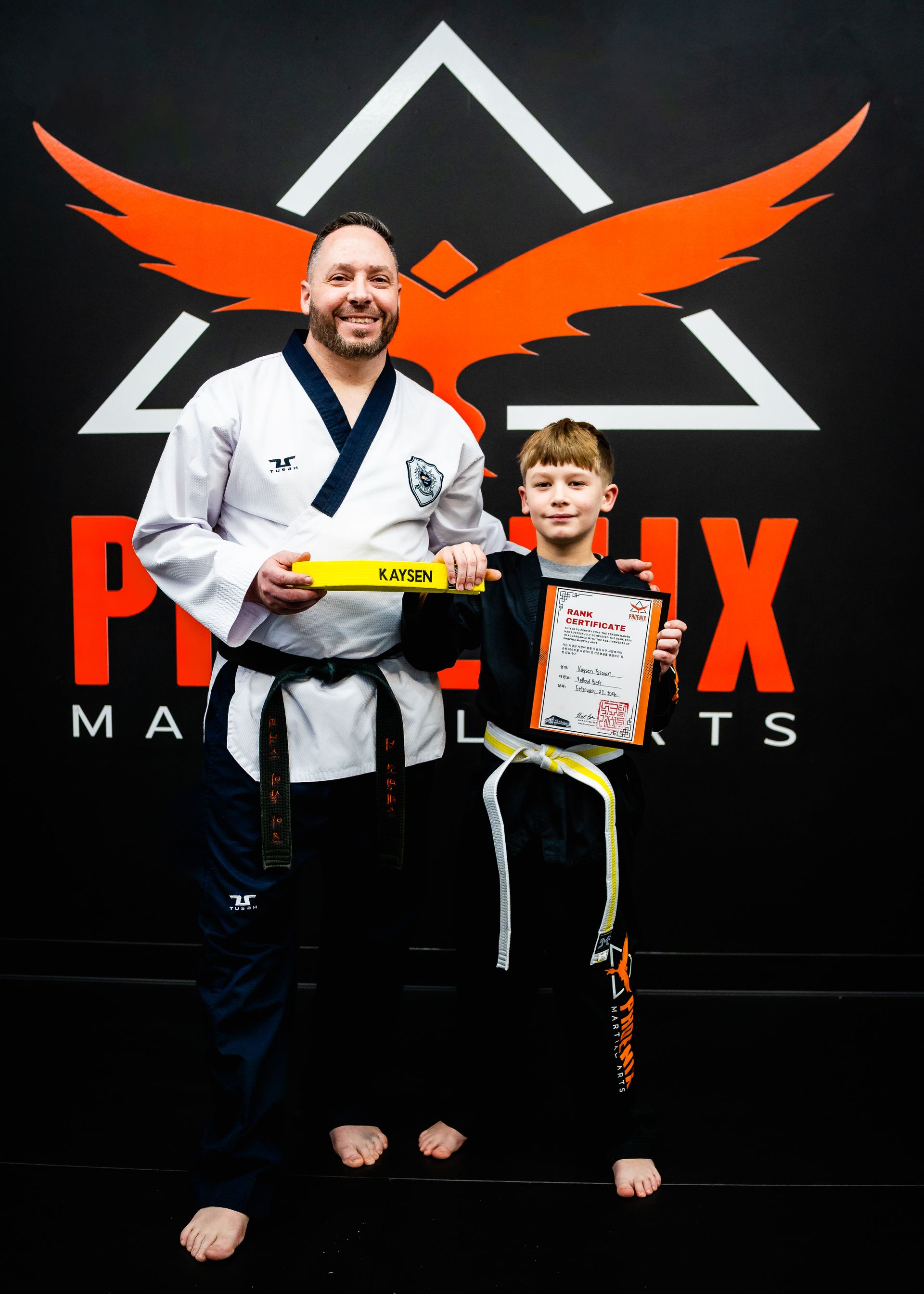 Young martial arts student celebrating a belt promotion at Phoenix Martial Arts in Murfreesboro, TN