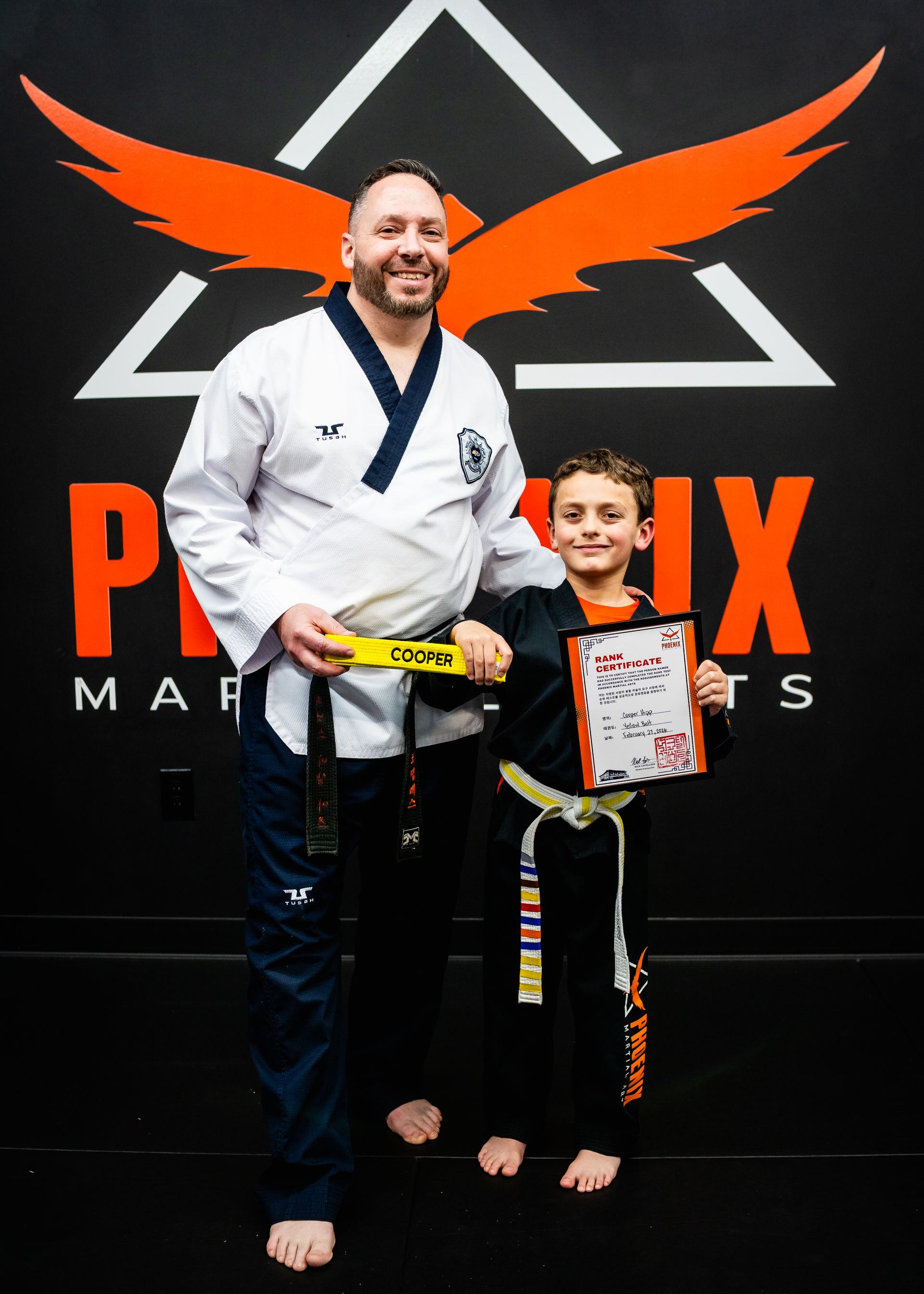 Young martial arts student celebrating progress and confidence at Phoenix Martial Arts in Murfreesboro, TN