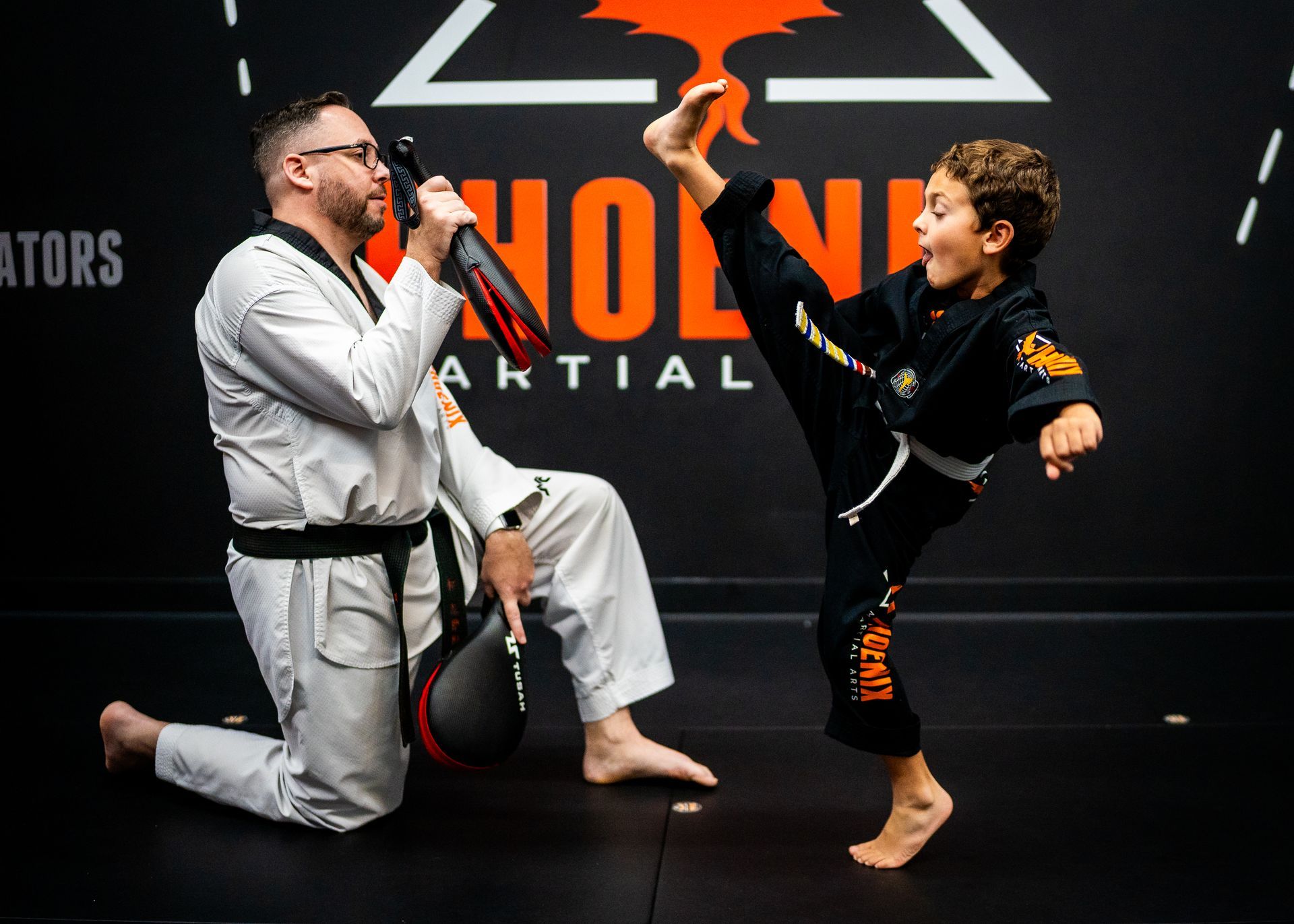 Child performing a drop kick during kids martial arts class at Phoenix Martial Arts in Murfreesboro, TN