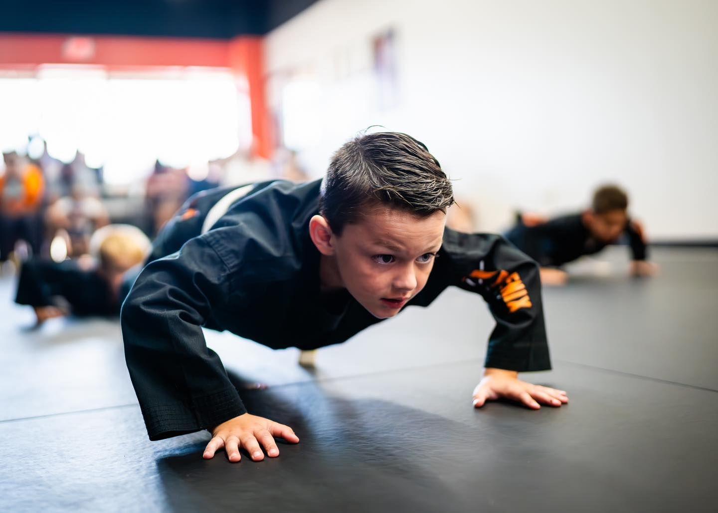 Student building strength and endurance during kids martial arts fitness training at Phoenix Martial Arts in Murfreesboro, TN