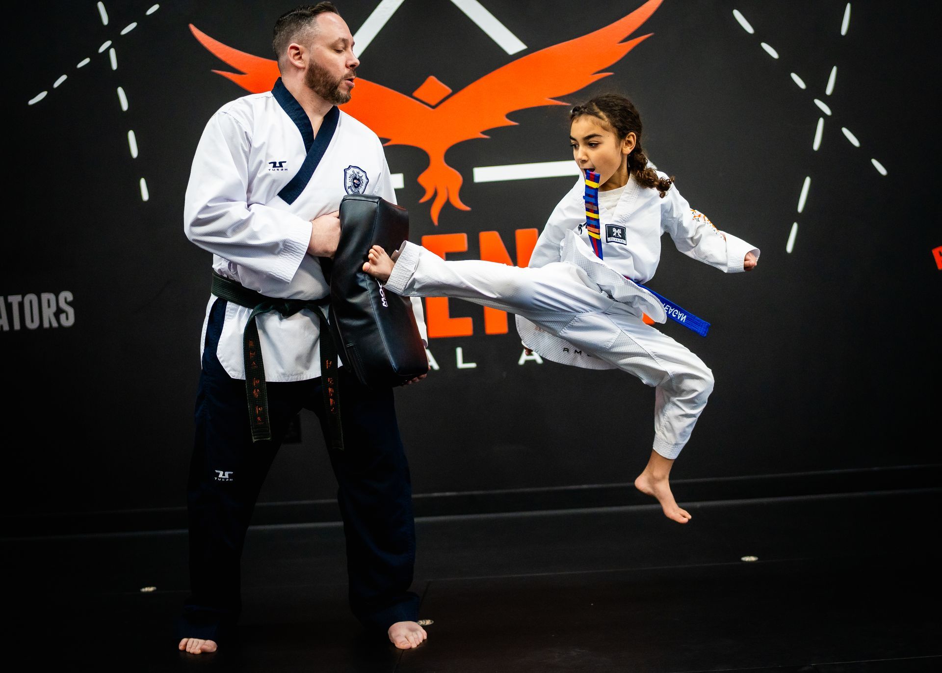 Student performing a jump kick during kids martial arts training at Phoenix Martial Arts in Murfreesboro, TN