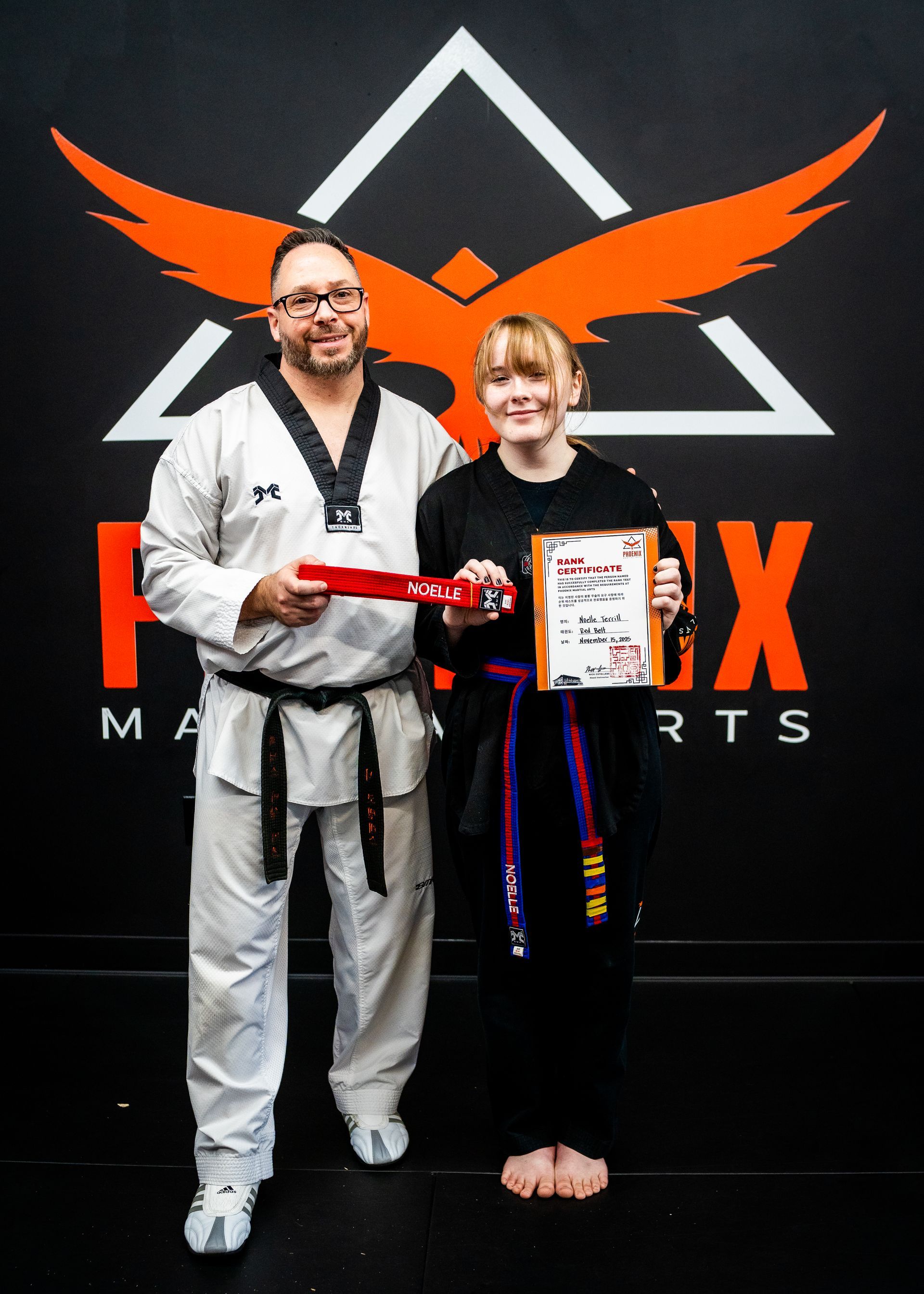 Teen student celebrating belt promotion after achieving a new rank at Phoenix Martial Arts in Murfreesboro, TN