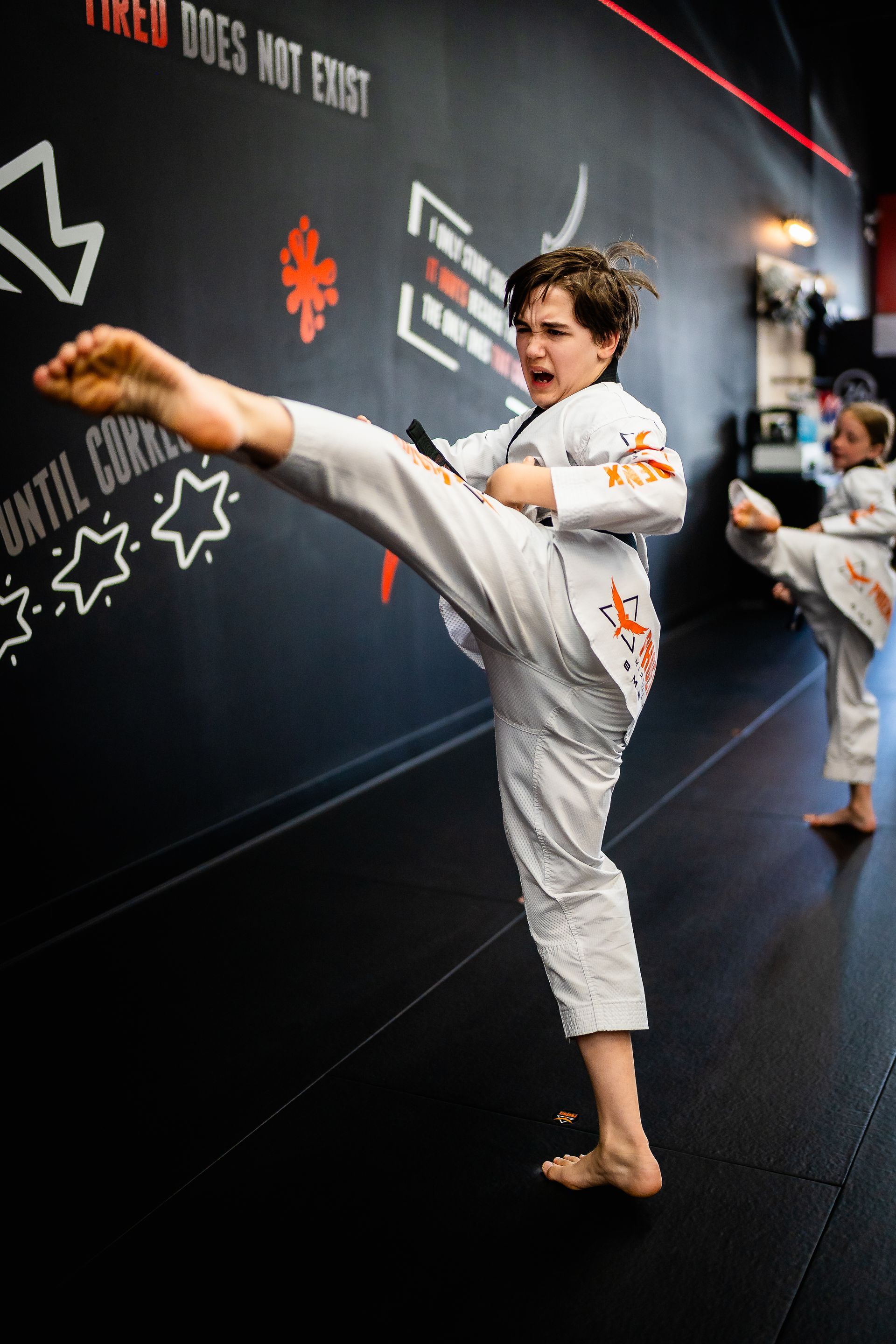 Teen martial arts student performing a powerful kick during Taekwondo training at Phoenix Martial Arts in Murfreesboro, TN