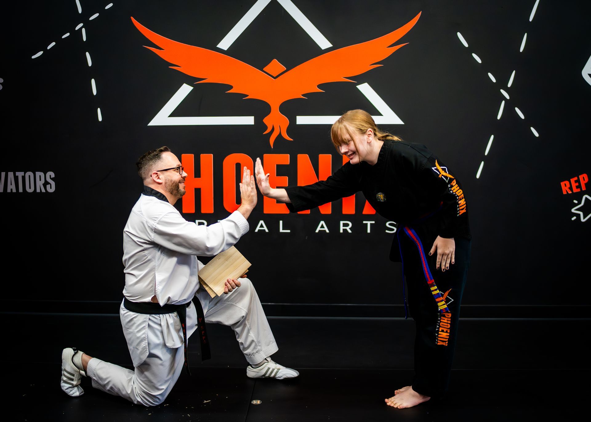 Teen martial arts student celebrating a hard-earned achievement at Phoenix Martial Arts in Murfreesboro, TN