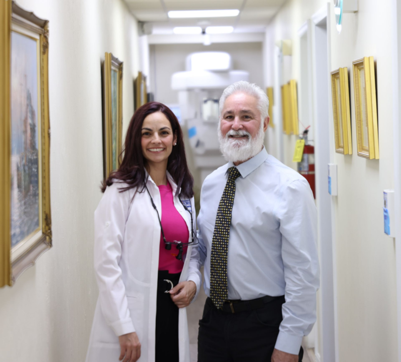 Dr. Rosado with a beard and tie is smiling for the camera.