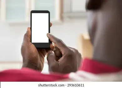 a man is holding a cell phone with a white screen .