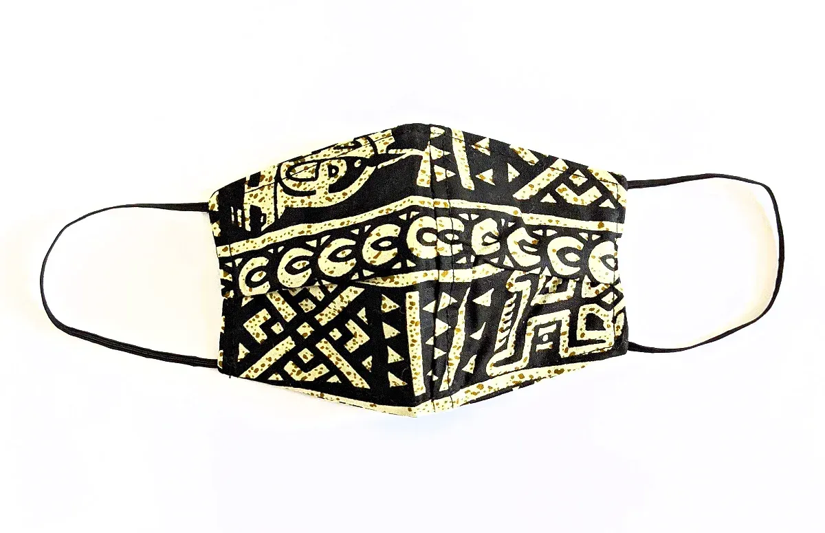 a black and gold face mask with a pattern on it on a white background .