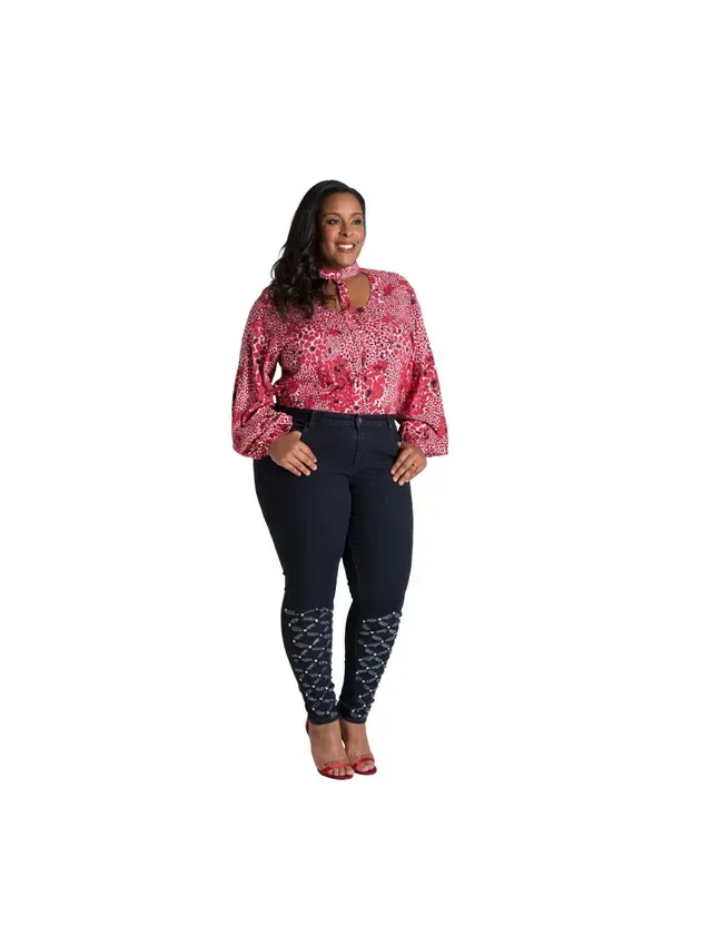 a plus size woman is wearing a pink blouse and blue pants .