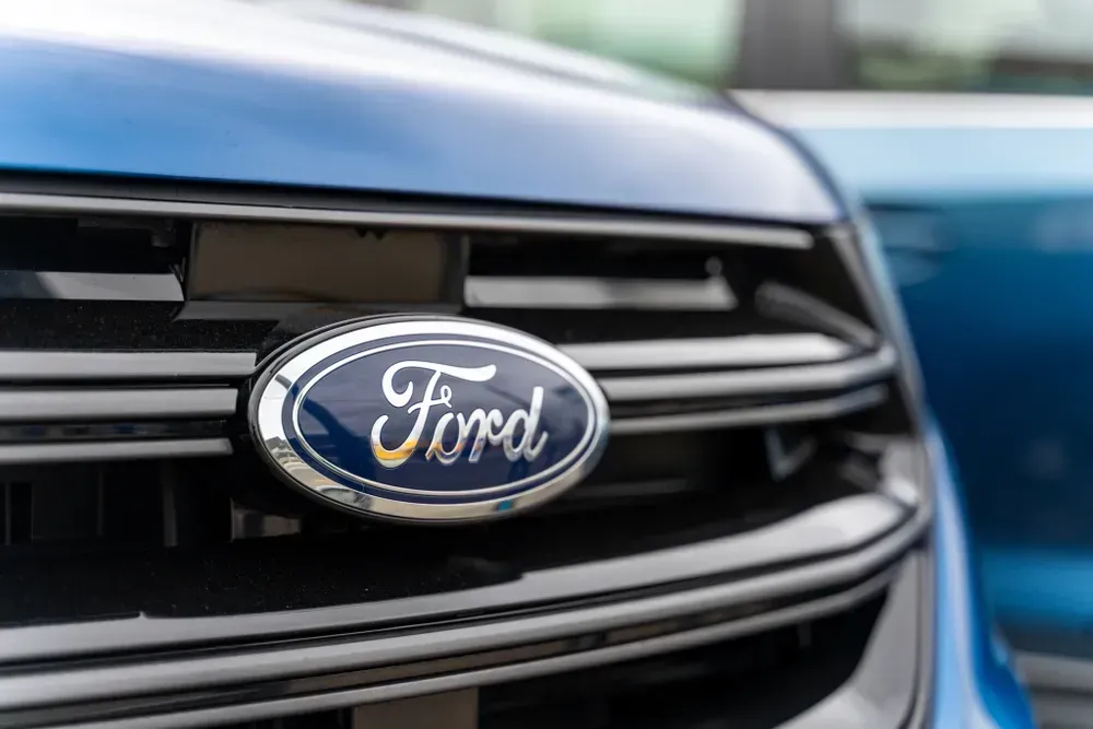 Close-up of a blue Ford car grille with the Ford emblem