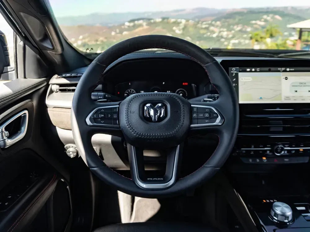 Close-up of a Toyota steering wheel with logo in a dark car interior