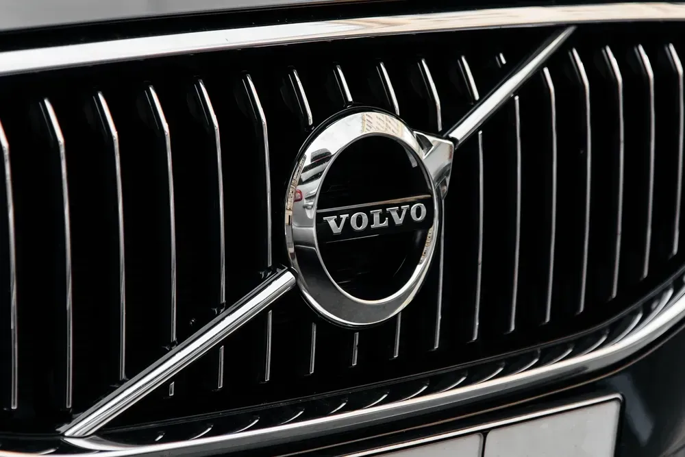Close-up of a Volvo car grille with chrome emblem and diagonal silver slash