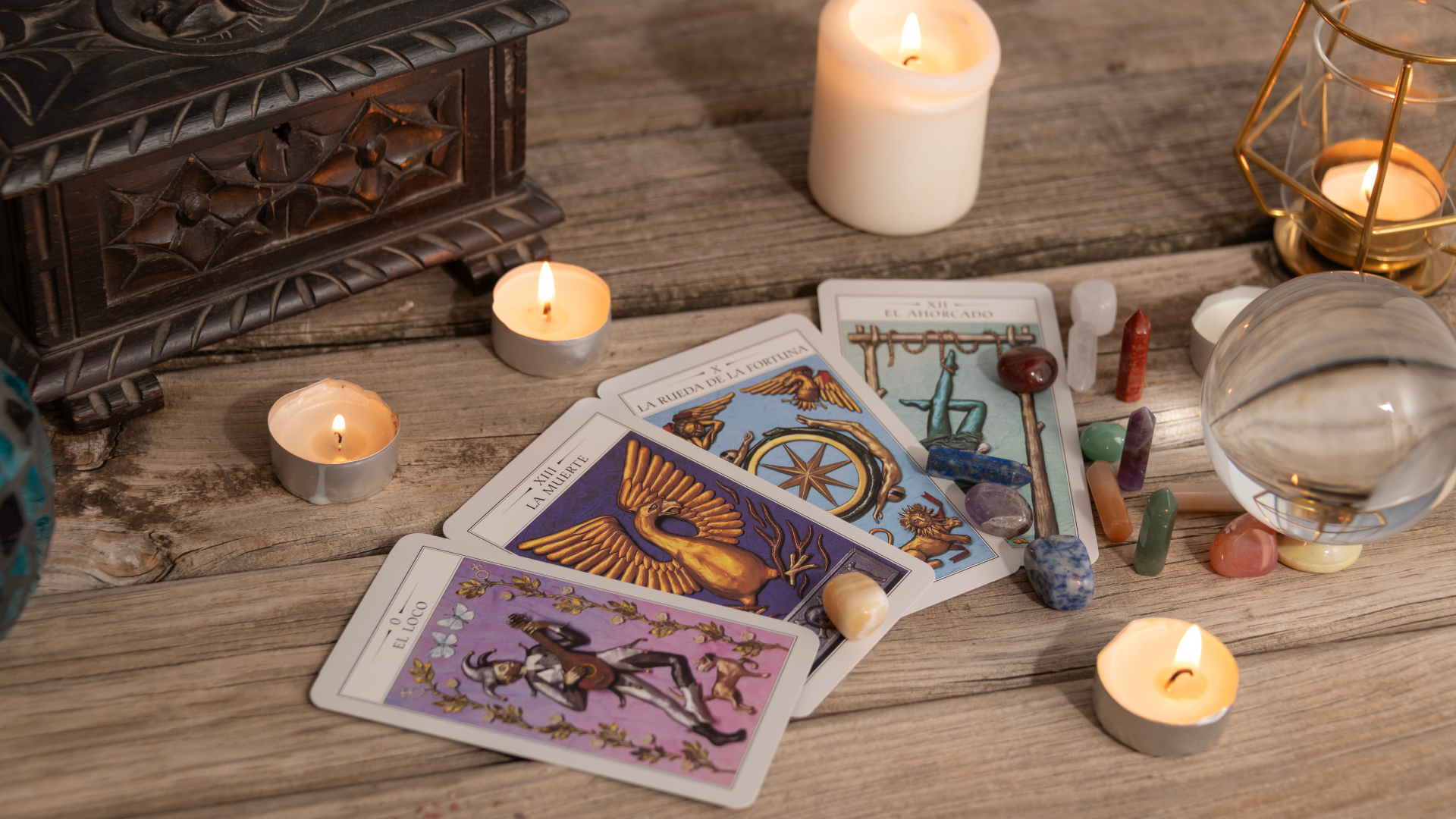 Tarot cards , candles , crystals and a glass ball spells, readings