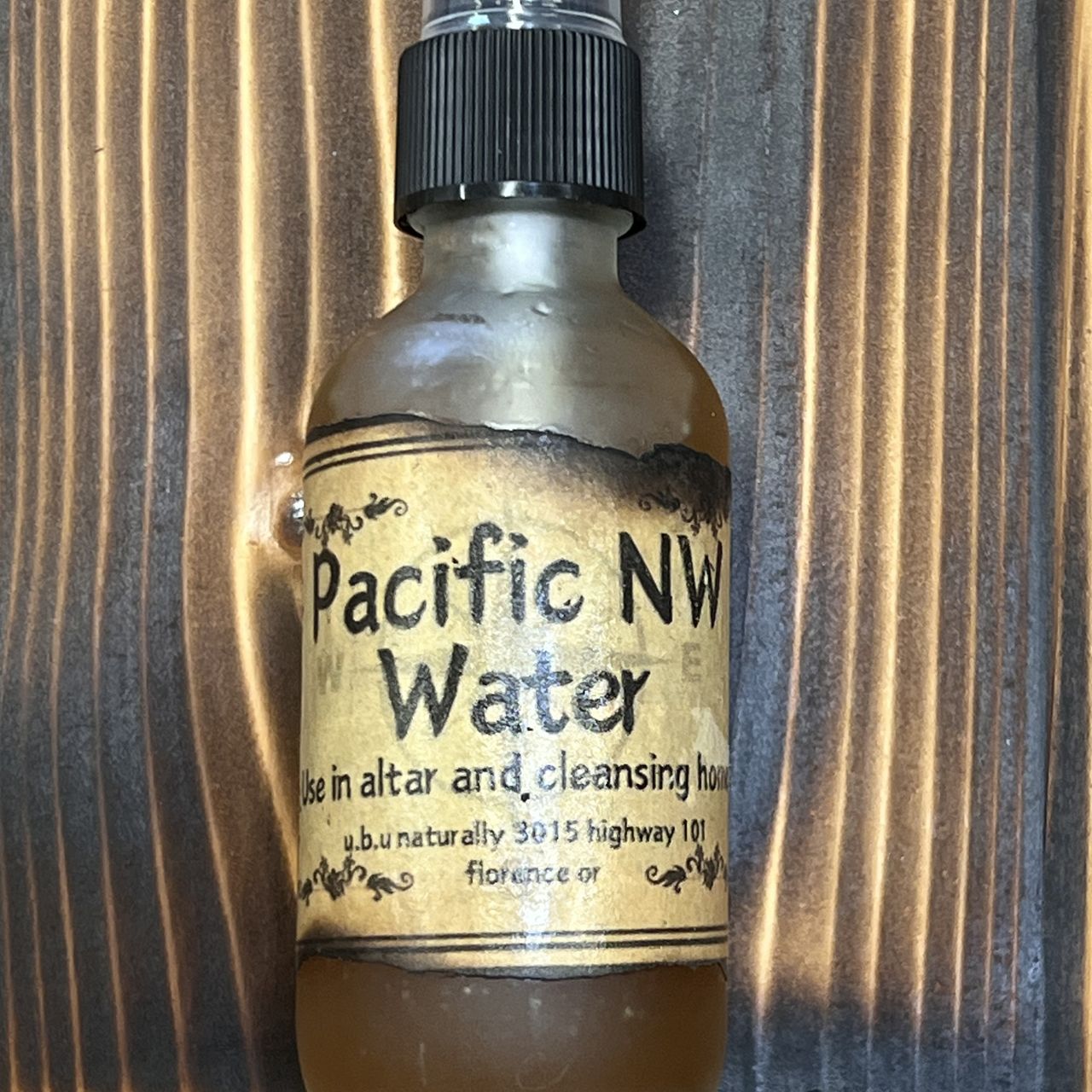 A bottle of pacific nw water is sitting on a table.