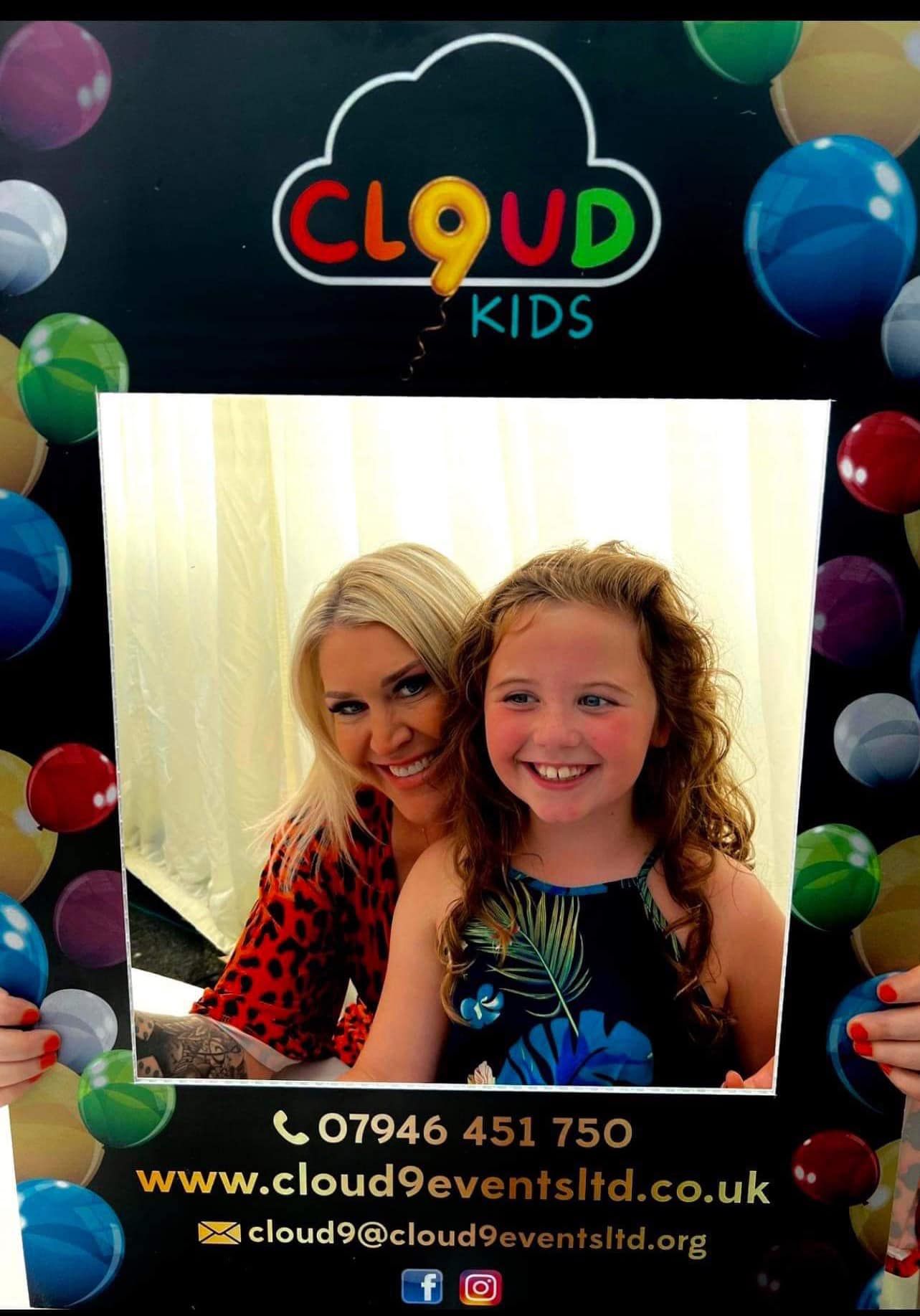 a woman and a little girl are posing for a picture .
