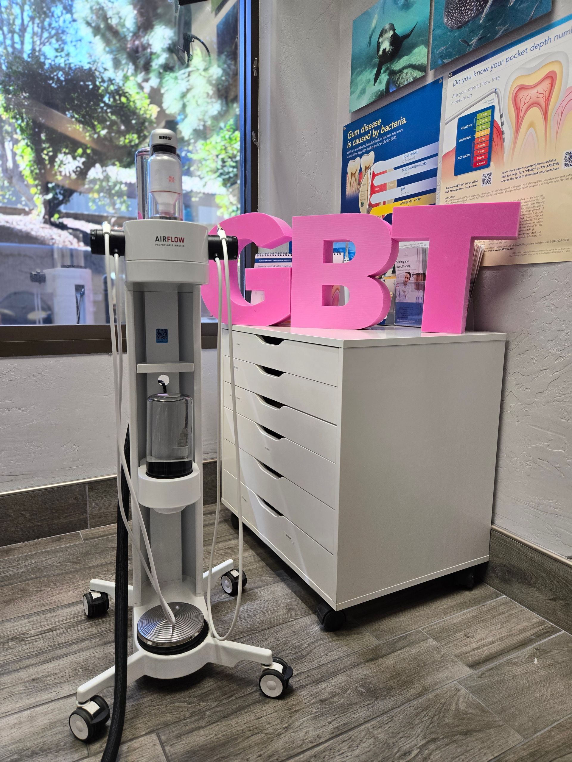 A pink cbt sign sits on top of a white cabinet
