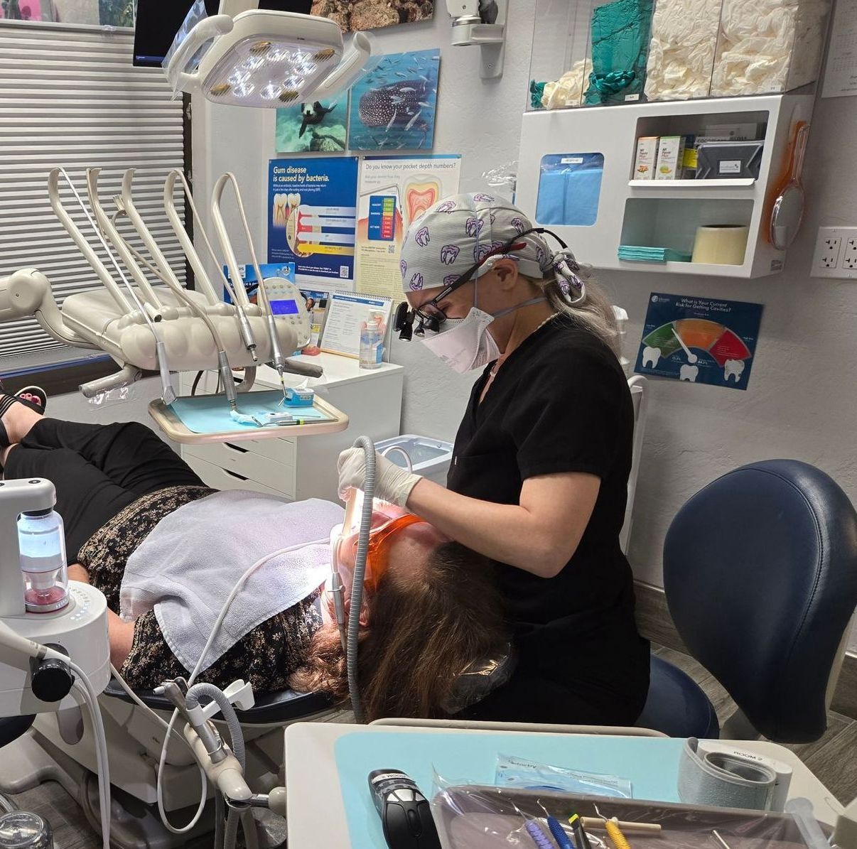 A woman is getting her teeth examined by a dentist
