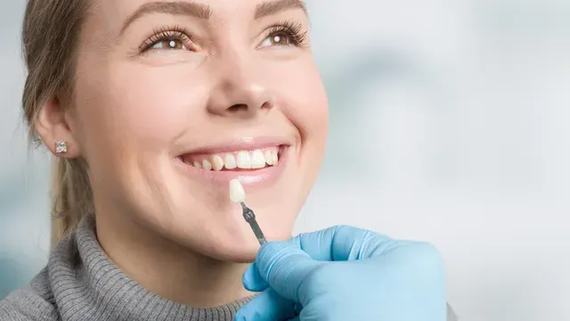 A dentist is looking at an x-ray of a patient 's teeth.
