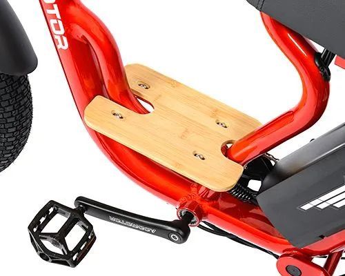Close-up of a red bicycle with a small wooden foot platform and black pedal.