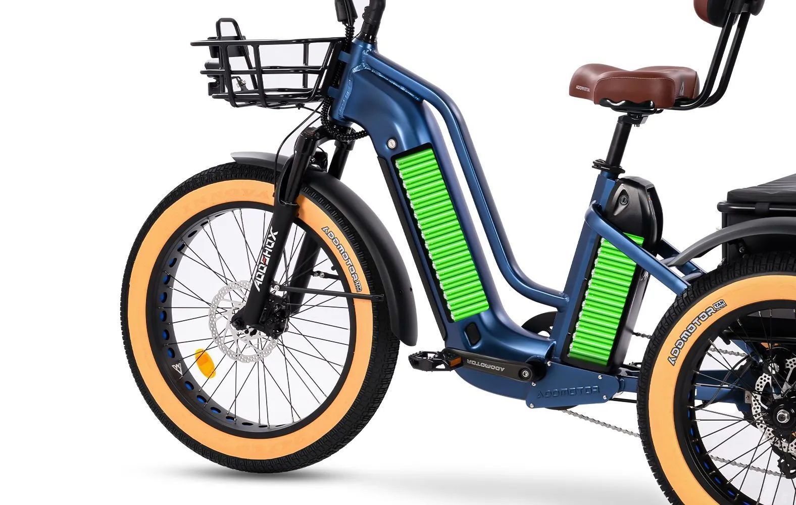 Blue electric bike with tan tires, front basket, and green battery panels on a white background