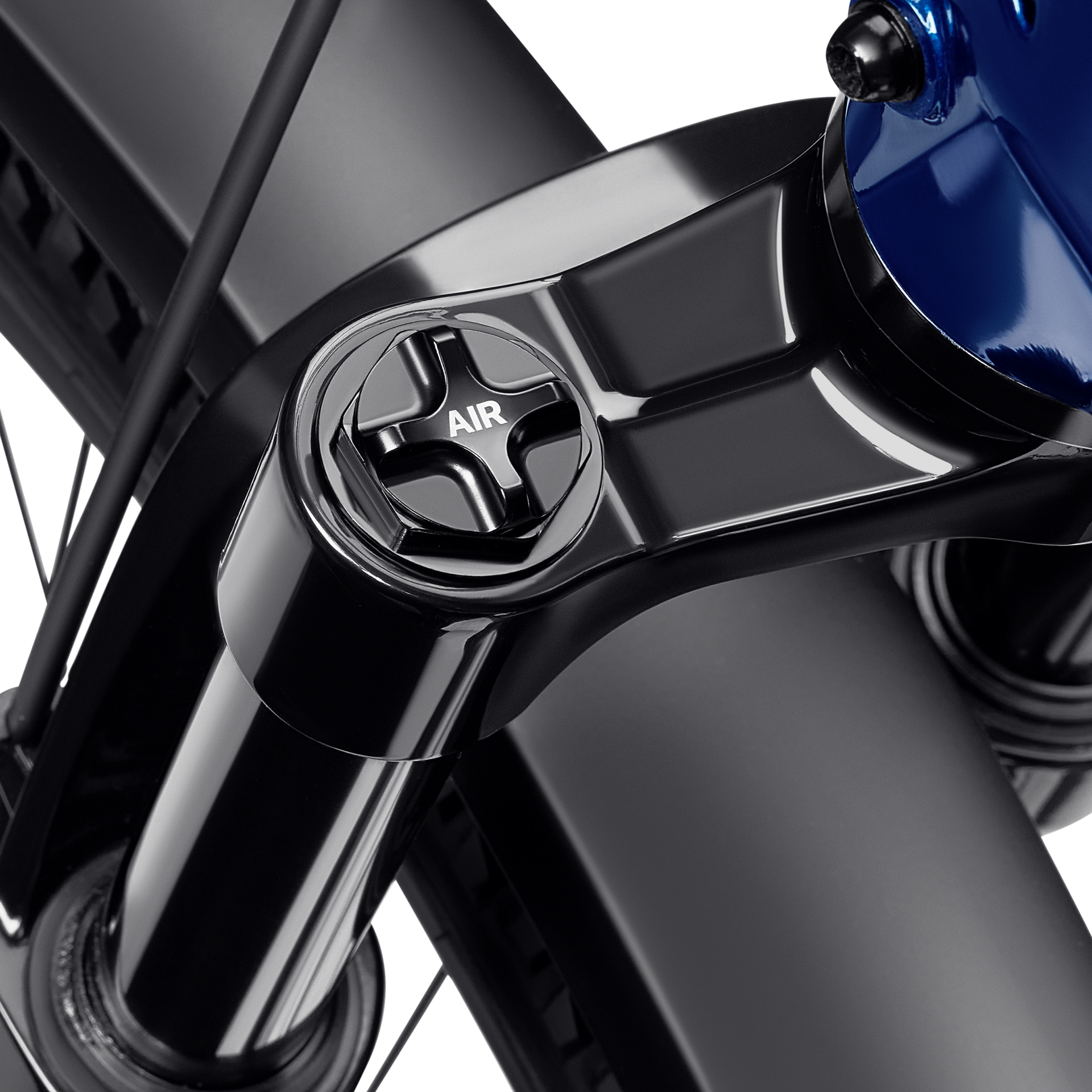 Close-up of a black bicycle front fork and blue frame with an AIR suspension adjustment knob