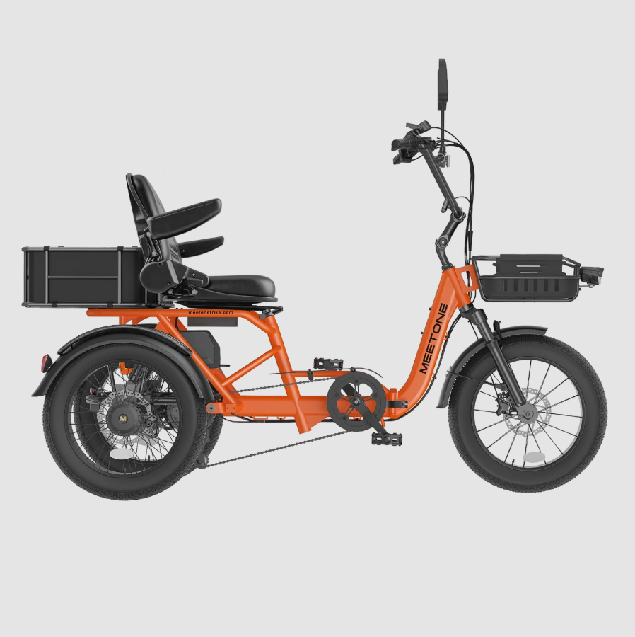 Orange cargo trike with black seat and rear storage box, shown in side view on a light gray background