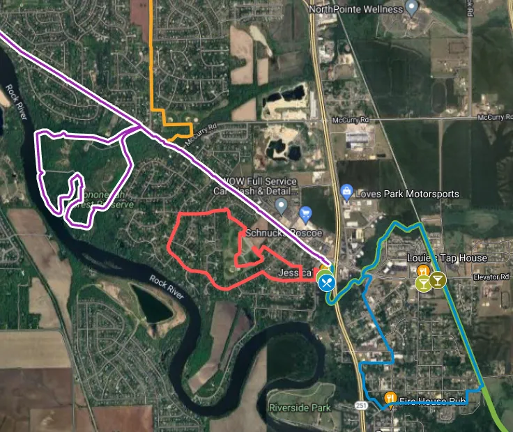 Satellite map with colored route outlines—purple, red, and blue—over roads, fields, and a river